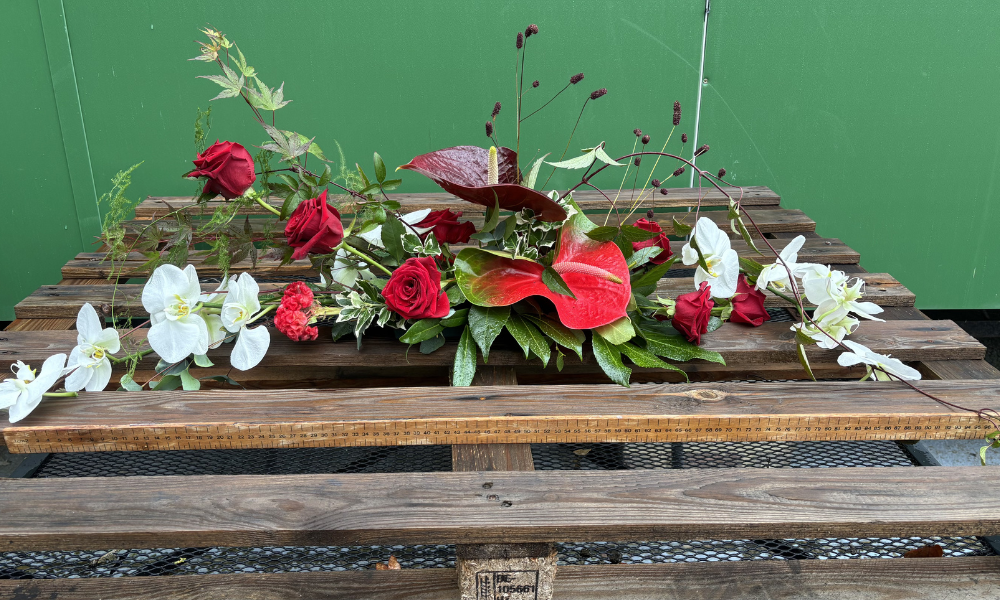 Sample arrangment with red roses, orchids with a blend of Japenese and English styles 